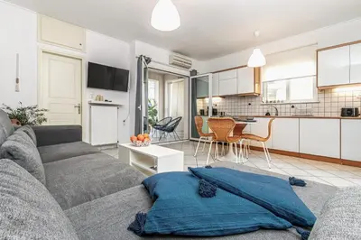 a living room with a couch and a kitchen at Easy Living City Apartment in Chania Town