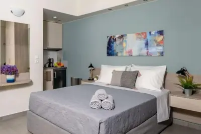 a bedroom with a large bed with towels on it at Ginger Chania City Center Apartment in Chania Town