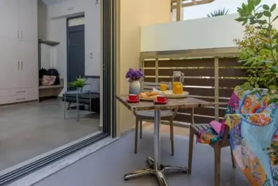 a living room with a table with food on it at Ginger Chania City Center Apartment in Chania Town