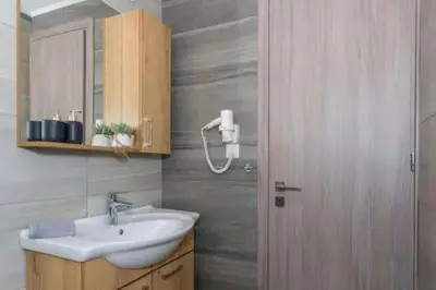 a bathroom with a sink and a mirror at Ginger Chania City Center Apartment in Chania Town