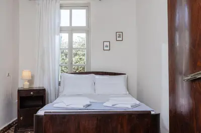 a bed in a room with a window at Argiro's House - Chania Old Town in Chania Town