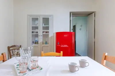a white table with a red refrigerator in a room at Argiro's House - Chania Old Town in Chania Town