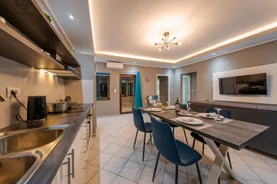 a kitchen and dining room with a table and chairs at Luxury Sea View Apartment in Kolimvari in Kolymvari