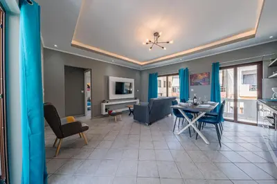 a living room with a table and a dining room at Luxury Sea View Apartment in Kolimvari in Kolymvari