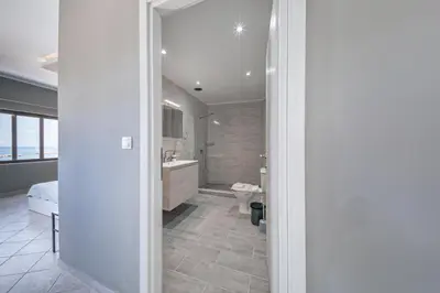 a bathroom with a toilet and a sink and a tub at Luxury Sea View Apartment in Kolimvari in Kolymvari