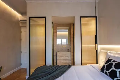 a bedroom with two mirrors and a bed in a room at La Torre Residenza Imperiale in Chania Town