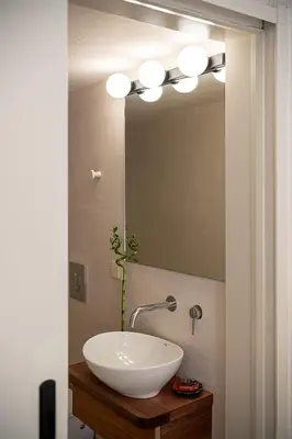 a bathroom with a white sink and a mirror at Faedra Residence in Chania Town