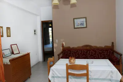 a room with a bed with a table with a cat on it at kera apartments in Kalyves