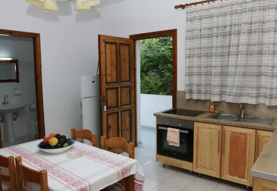 a kitchen with a table with a bowl of fruit on it at kera apartments in Kalyves