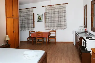 a kitchen and dining room with a table and chairs at kera apartments in Kalyves