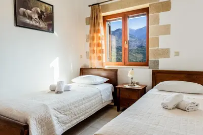 a bedroom with two beds and a window at Ktima Edem in Ramní