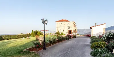 a building with a street light in front of a yard at Ktima Edem in Ramní
