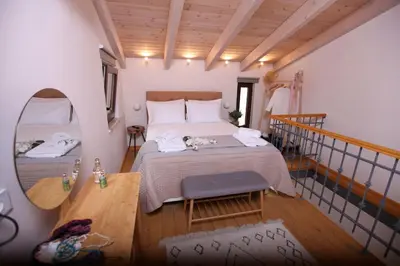 a bedroom with a large bed and a staircase at Kabanas 3 cosy suite in Chania Town