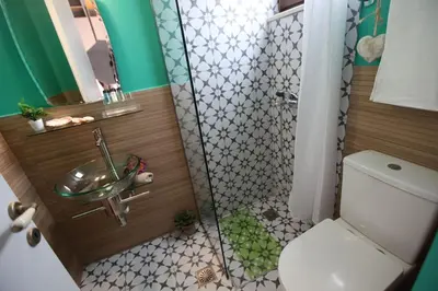 a bathroom with a shower with a sink and a toilet at Kabanas 3 cosy suite in Chania Town