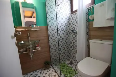 a bathroom with a toilet and a sink and a mirror at Kabanas 3 cosy suite in Chania Town