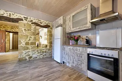 a kitchen with a stove and a refrigerator at Apartments Panethimos in Panéthimos