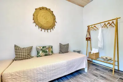 a bedroom with a bed and a wreath on the wall at Apartments Panethimos in Panéthimos