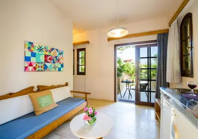 a living room with a couch and a table at Evangelos Apartments in Plataniás