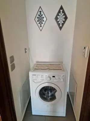 a washer and dryer in a small room at Korais apartment, Chania Crete in Kounoupidhianá