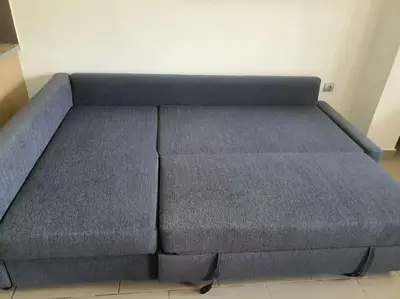 a large blue couch sitting in a room at Korais apartment, Chania Crete in Kounoupidhianá