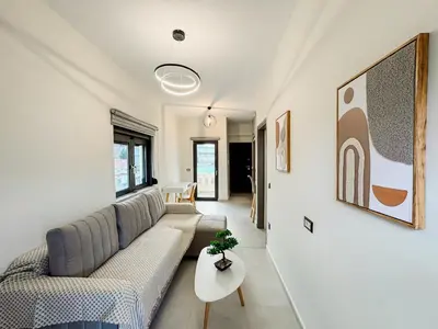 a living room with a couch and a table at Comfy Corner Luxury Apartment in Chania Town