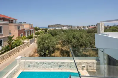 a view from the balcony of a house with a swimming pool at Megalith Villas in Agia Marina Nea Kydonias
