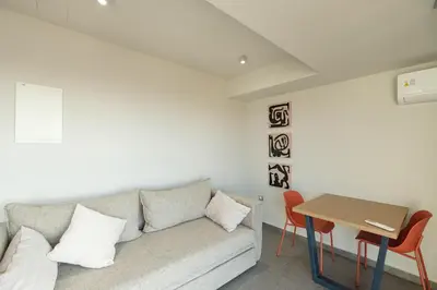 a living room with a couch and a table at Sky-High Central Penthouse w. Stunning Views - 01 in Chania Town