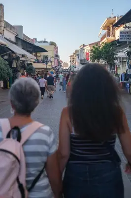 two women walking down a city street at Sky-High Central Penthouse w. Stunning Views - 01 in Chania Town