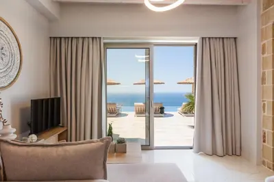 a living room with a view of the ocean at Flower Village in Chania Town