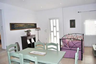 a dining room with a table and chairs at Chrysiida Suites in Tersanas