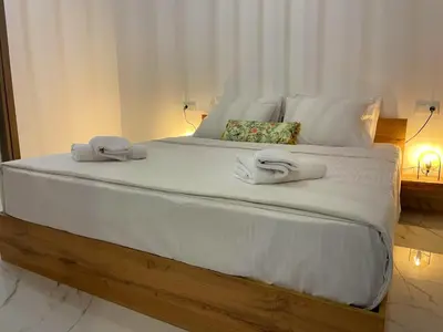 a large white bed with two towels on it at SK Luxury Residence in Chania Town
