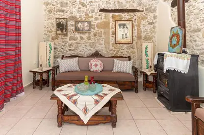 a living room with a couch and a table at Kantoni traditional house in Maláthiros