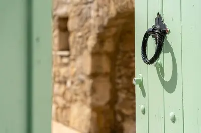 a door with a black rope hanging on it at Kantoni traditional house in Maláthiros