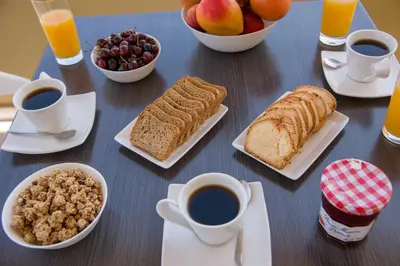 a table with breakfast foods and cups of coffee at Casa Di Halepa in Chania Town