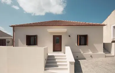 a white house with stairs in front of it at Villa Methexis in Arménoi