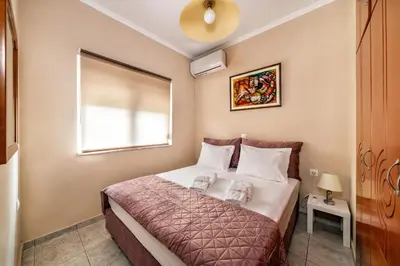 a small bedroom with a bed in a room at House On The Beach In Kera - BY APOKORONAS VILLAS in Kalyves