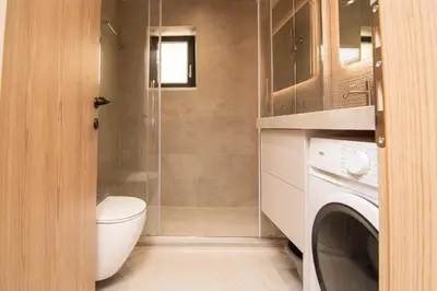 a bathroom with a toilet and a glass shower at Place of the Gοds in Palaiochóra