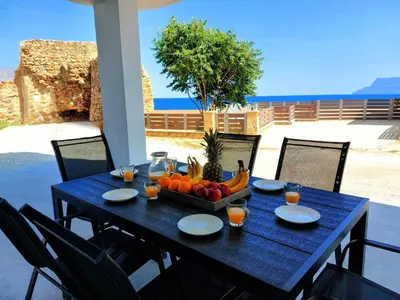 a blue table with a bowl of fruit on it at Blue Horizon Kissamos Apartment in Kissamos