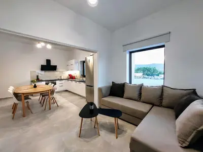 a living room with a couch and a table at Blue Horizon Kissamos Apartment in Kissamos