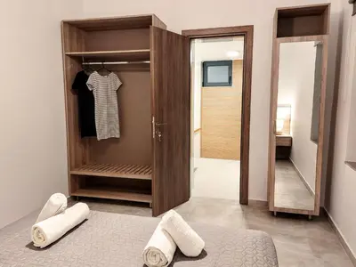 a room with a closet with towels and a mirror at Blue Horizon Kissamos Apartment in Kissamos