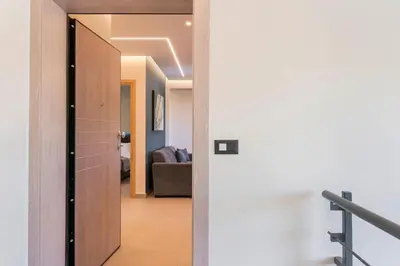 a hallway with a door leading to a living room at Aspect Luxury Apartments with Pool in Galangádhos
