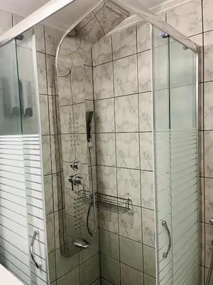 a bathroom with a shower with a glass door at Dream Apartments in Palaiochóra