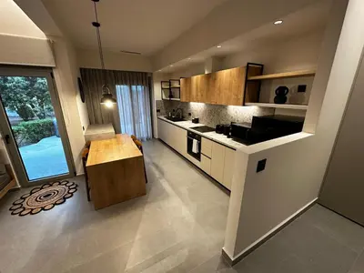 a large kitchen with a table and a large window at GREEN ESTATE villas in Arménoi