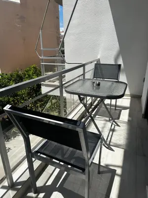 a table and chairs sitting on a balcony at Maria's Cozy Chania Apartment in Chania Town
