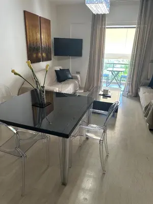 a living room with a table and a couch at Maria's Cozy Chania Apartment in Chania Town