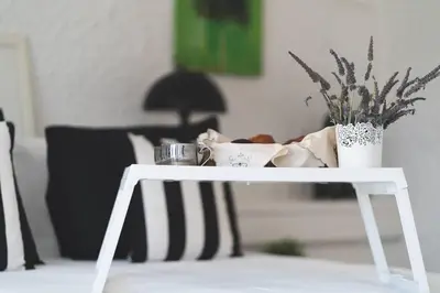 a white table with a plant on it in a living room at Labyrinth. The Wild life of Crete in Katsifarianá