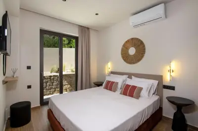 a bedroom with a white bed and a window at Armour Eclectic Villa in Afráta
