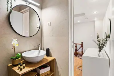 a bathroom with a sink and a mirror at Rodon maisonette in Chania Town