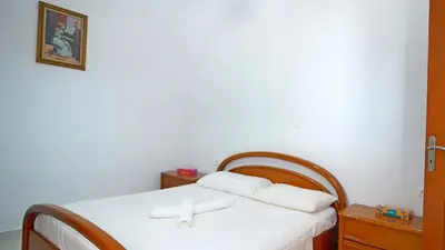 a bed with two white pillows on top of it at Polyraki's Cottage in Chania Town