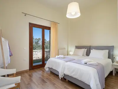 a bedroom with two beds and a window at Villa Magia in Stérnai